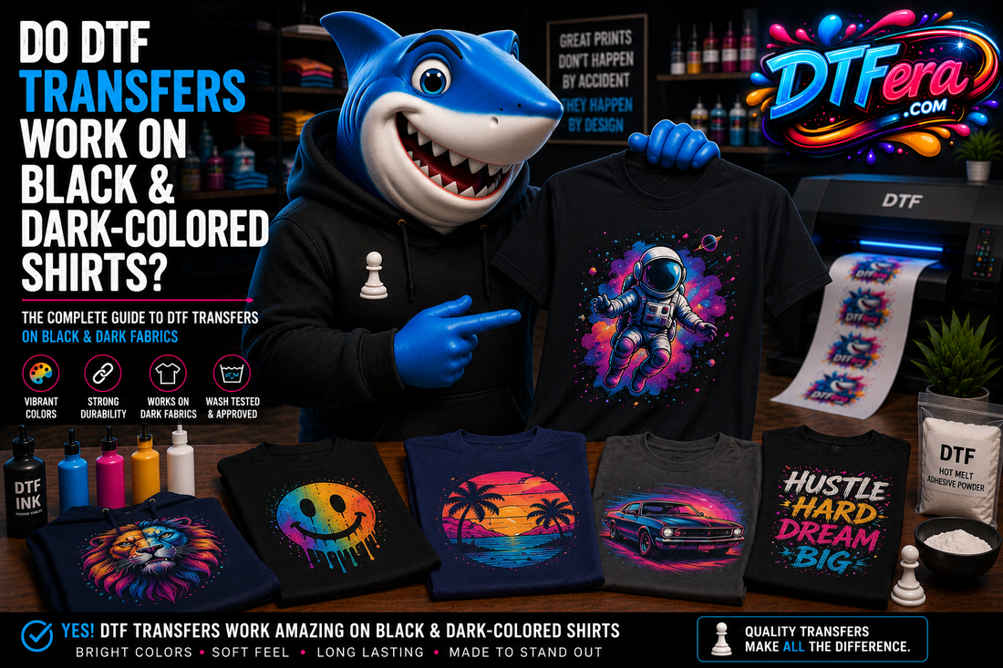 Shark mascot showcasing vibrant DTF transfers applied to black and dark-colored shirts in a professional DTF printing studio.